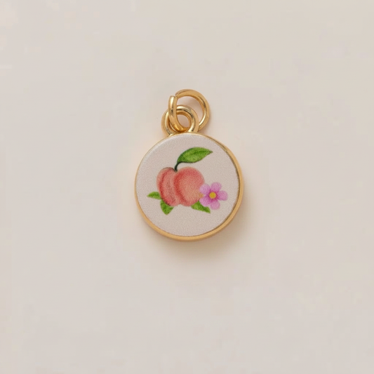 Peach enamel charm - cream background
